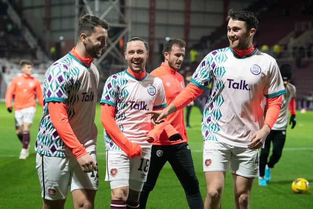 Craig Halkett, Barrie McKay and John Souttar share a laugh before kick-off as the Hearts stars parade the FC United to Prevent Suicide strips. Picture: SNS