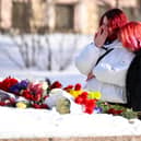 A young woman cries after laying flowers for late Russian opposition leader Alexei Navalny at the Solovetsky Stone, a monument to political repression that has become one of the sites of tributes for Navalny. (Photo by NATALIA KOLESNIKOVA/Getty Images)