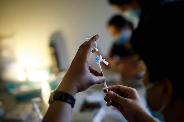 Nurse Kevin Sagun with Humber River Hospital draws a dose of the Moderna Covid-19 vaccine before administering it at a LOFT community housing complex in Toronto, Ontario, Canada(Photo by COLE BURSTON/AFP via Getty Images)