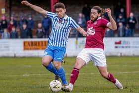 Penicuik striker Nicky Reid, holding off Linlithgow's Willis Hare, is moving to Edinburgh City
