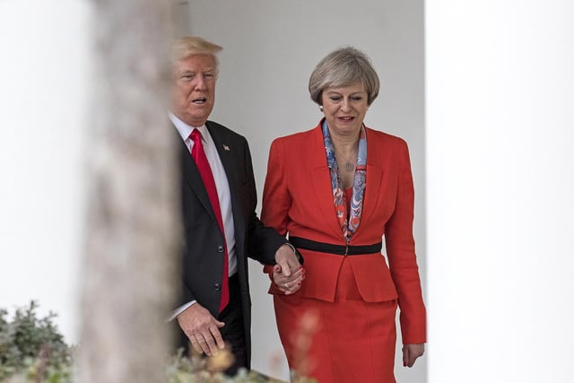 British Prime Minister Theresa May and U.S. President Donald Trump walk along The Colonnade of the West Wing at The White House on January 27, 2017 in Washington, DC. Apparently....Trump suffers from Bathmophobia (yes, that's a thing) which is a fear of stairs.  That's why he needed to hold her hand - coz he was scared...