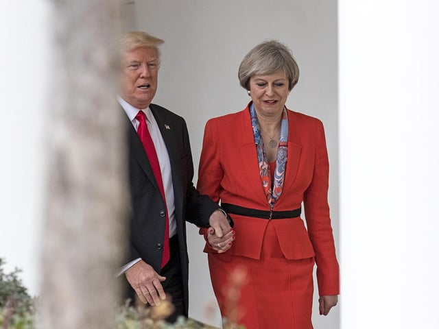 British Prime Minister Theresa May and U.S. President Donald Trump walk along The Colonnade of the West Wing at The White House on January 27, 2017 in Washington, DC. Apparently....Trump suffers from Bathmophobia (yes, that's a thing) which is a fear of stairs.  That's why he needed to hold her hand - coz he was scared...