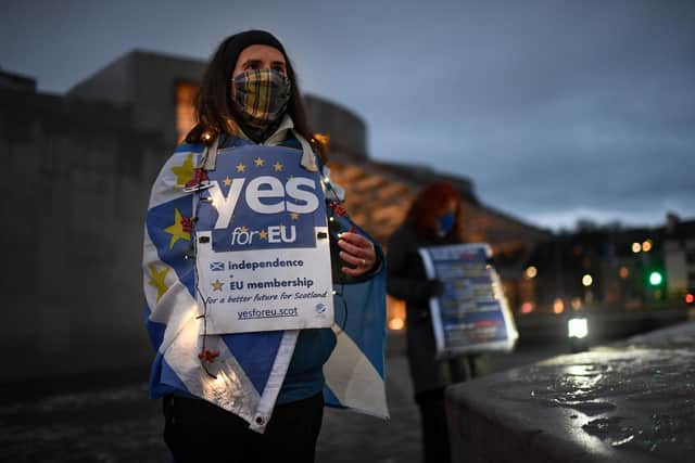 Pro-EU demonstrators gather outside the Scottish Parliament for a protest against Brexit on December 31, 2020, the day the UK formally left the European Union (Picture: Jeff J Mitchell/Getty Images)