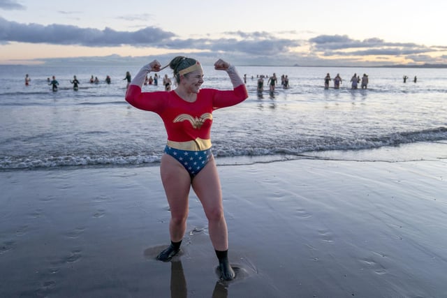 One attendee dressed as Superwoman flexed her muscles before diving into the Firth of Forth.