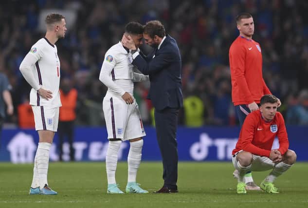England manager Gareth Southgate consoles Jadon Sancho after defeat in the penalty shootout that decided the Euro 2020 final (Picture: Laurence Griffiths/pool via AP)