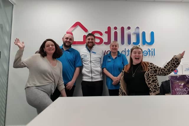 Rachael (right) and Levi (left) with staff at the Utilita store in Leith.