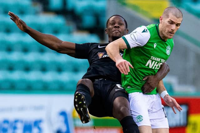 Getting to grips with Marvin Bartley during a clash between Hibs and Livingston
