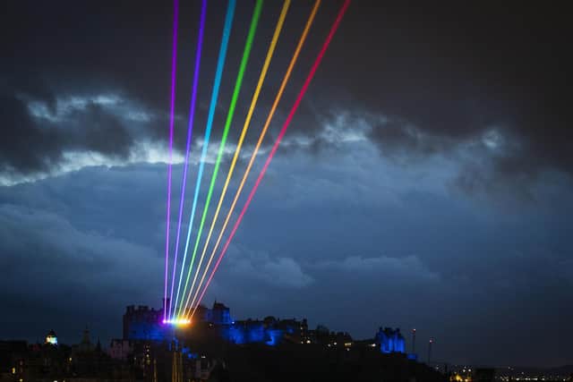 The night sky in Edinburgh was lit up by a 'Global Rainbow' laser art installation as a message of 'love, hope and optimism' from the city to the rest of the world. Picture: Jane Barlow/PA Wire