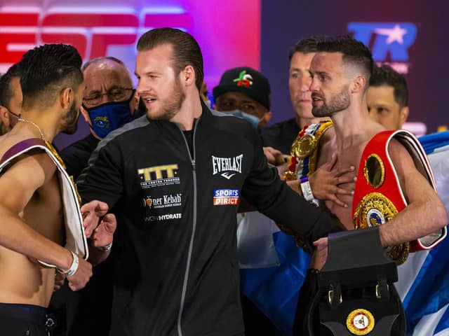Ben Davison, centre, trainer for Josh Taylor keeps him apart from Jose Ramirez as the two face off following the weigh-in in Las Vegas. Picture: Chase Stevens/AP