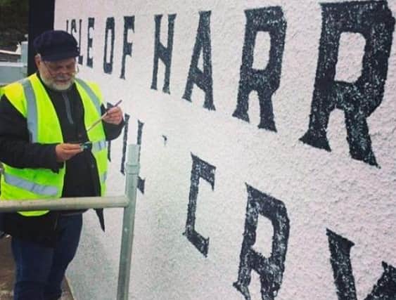 Robin Abbey painting the Isle of Harris Distillery sign, a project he and Tatch worked on together picture: Tatch Hatch Robertson