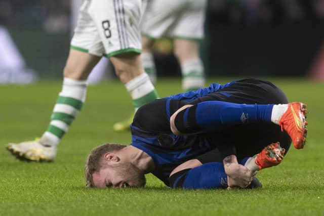 Nathaniel Atkinson goes down injured after a tackle from Celtic's Alexandro Bernabei, which was checked by VAR. Picture: Craig Foy / SNS