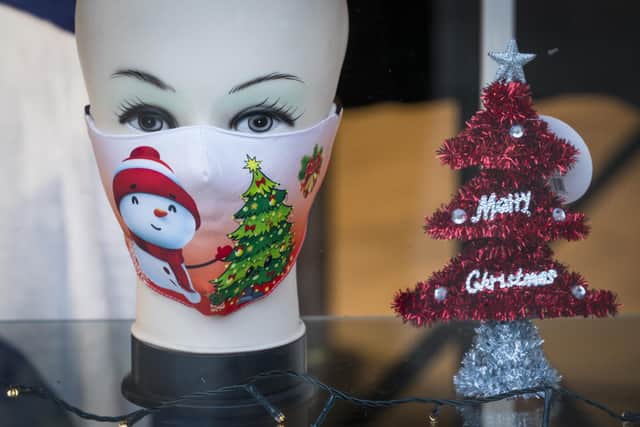 Christmas themed face masks for sale on display in a shop window on Edinburgh's Princes Street. Scotland is currently using a tier system to try and drive down coronavirus cases.