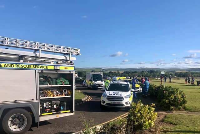 Emergency services rescued three children and an adult from the sea near Belhaven Bay.