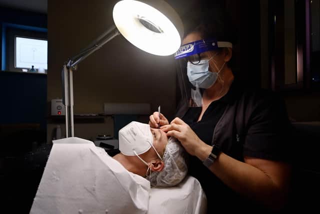 Allowing customers to remove masks for beauty treatments would help salons 'save themselves from the brink', according to the group (file image). Picture: Eric Lalmand/Belga/AFP via Getty Images.