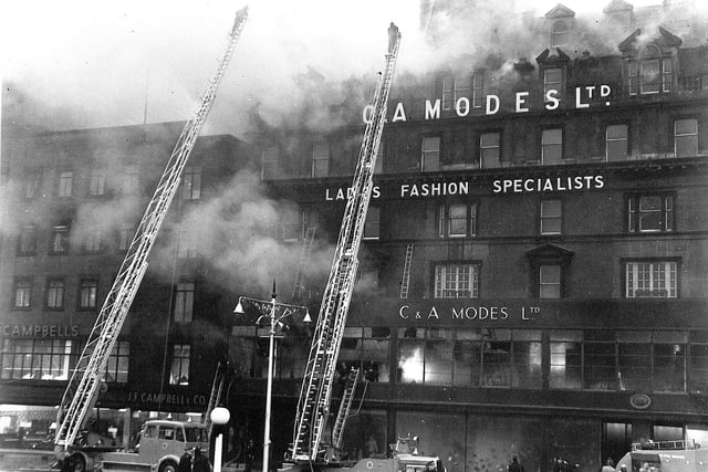 Fireman on turntable ladders battle the blaze at C&A department store on Princes Street, Edinburgh on November 9 1955. The Victorian building was demolished and replaced by a new build.