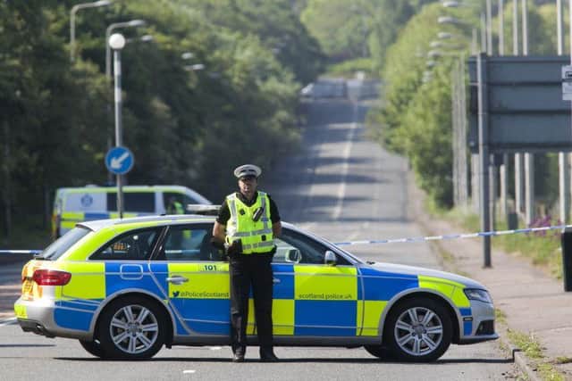 Police Scotland officers guarding the crime scene.