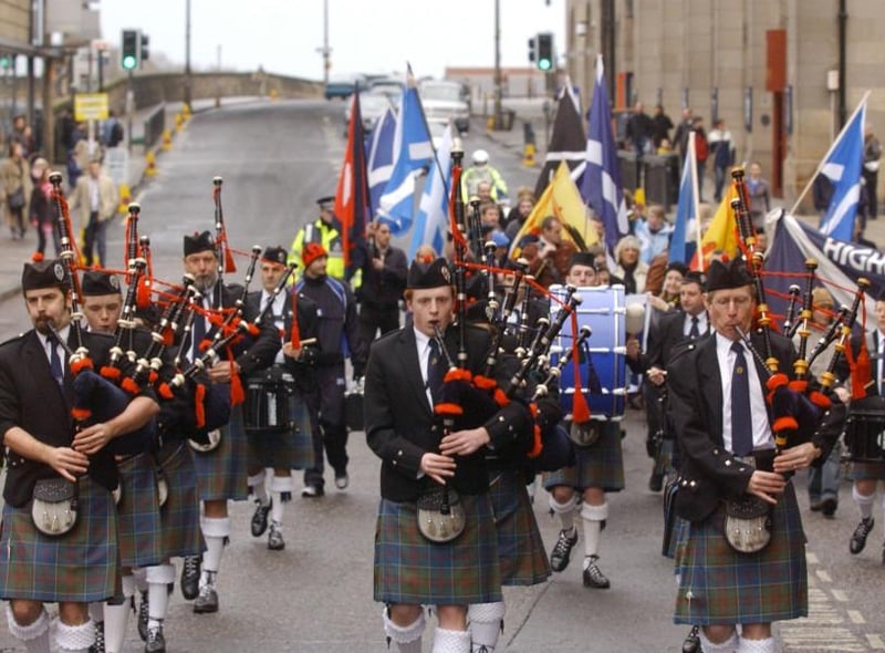 Pipers from the Stockbridge Pipe Band lead the colourful St Andrews Day march along the capital's Princes Street in 2003.