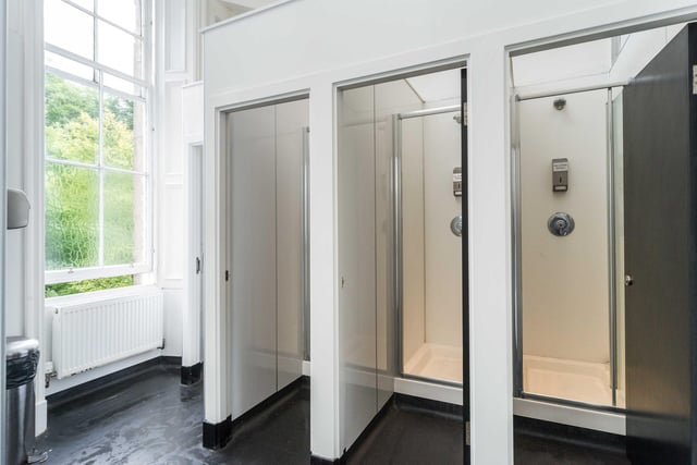 There are also communal shower room facilities on the first floor for guests in the non-en-suite dormitories and a mirrored vanity area with hairdrying facilities .