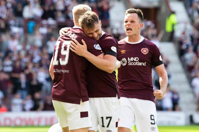 Alan Forrest celebrates with Alex Cochrane and Lawrence Shankland (right) after opening the scoring at Tynecastle Park. Picture: SNS