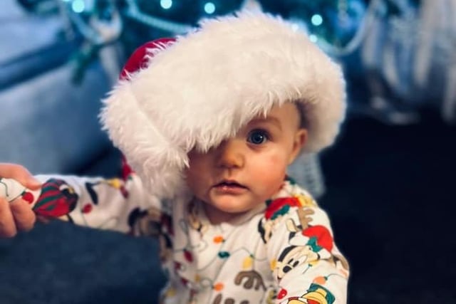 11 month old Ashlyn in a Santa hat. Submitted by Laura McHugh.