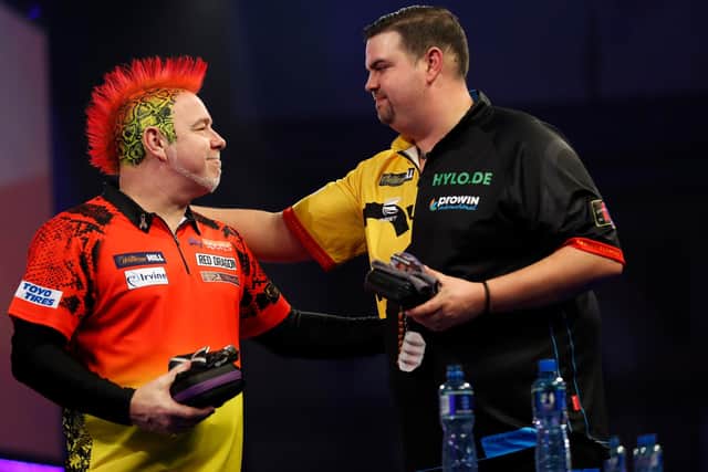World champion Peter Wright, left, suffered a shock third-round defeat at the hands of Gabriel Clemens of Germany. Picture: Luke Walker/Getty Images