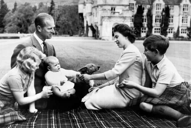 Britain's Queen Elizabeth II (2R), Britain's Prince Philip, Duke of Edinburgh (2L) and their three children Prince Charles (R), Princess Anne (L) and Prince Andrew (3L) pose in the grounds of Balmoral Castle, near the village of Crathie in Aberdeenshire, September 9, 1960. (Photo by - / - / AFP) (Photo by -/-/AFP via Getty Images)