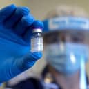 An NHS worker holds up a vial of the Pfizer-Biontech Covid-19 vaccine (Photo: CHRIS JACKSON/POOL/AFP via Getty Images)