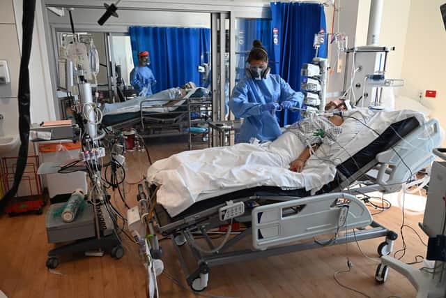 A Covid patient lies in an NHS intensive care unit (Picture: Neil Hall/pool/Getty Images)