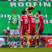 Aberdeen protest to referee Willie Collum after Jamie Murphy won a penalty during Hibs' 2-0 win. Picture: SNS