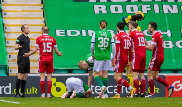 Aberdeen protest to referee Willie Collum after Jamie Murphy won a penalty during Hibs' 2-0 win. Picture: SNS