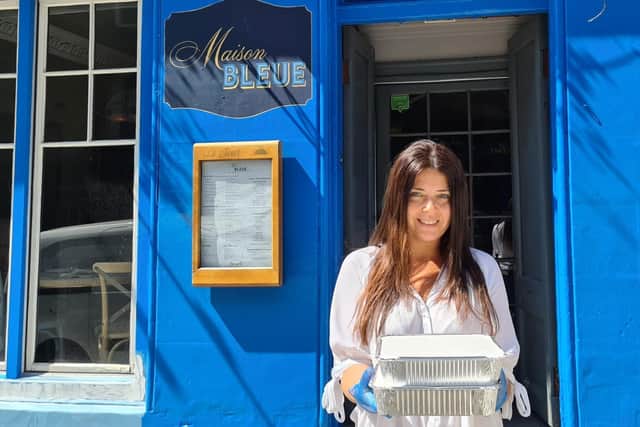 Layla Gassabi, co-owner at Maison Bleue, outside the restaurant with two of the meals.