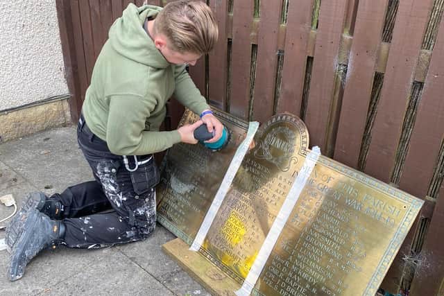 Mr Mitchell hard at work cleaning, mending and polishing the memorial.