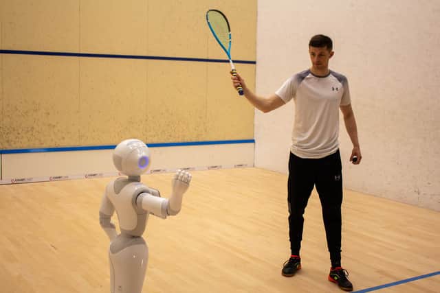 Human player gets feedback on court from a social robot coach