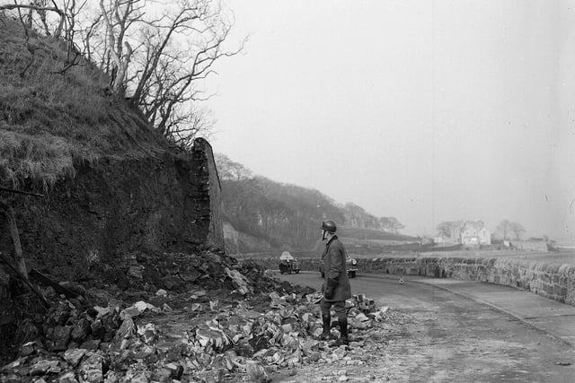 The road to Edinburgh just outside Prestonpans was blocked by a fallen wall in April 1963.