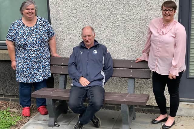 Melville tenants Shona (left) and Sam Wilkie (centre) and Melville housing officer Emma Shanks (right) with the new garden bench.