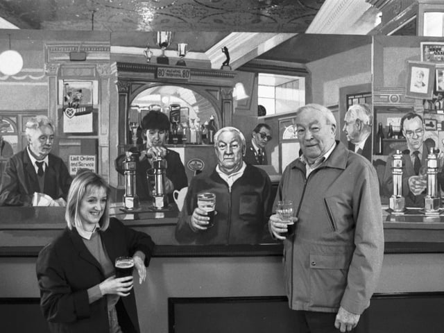 Athletic Arms regular Sandy Dick sees himself as others see him when Edinburgh artist Margaret Milne unveils her painting The Diggers Triptych 1988 at the Edinburgh pub in November 1988.