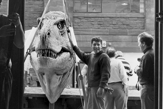 A giant Tyrannosaurus Rex head is unloaded by workmen for the Dinosaurs Alive! exhibition at the City Art Centre in Edinburgh, February 1990.