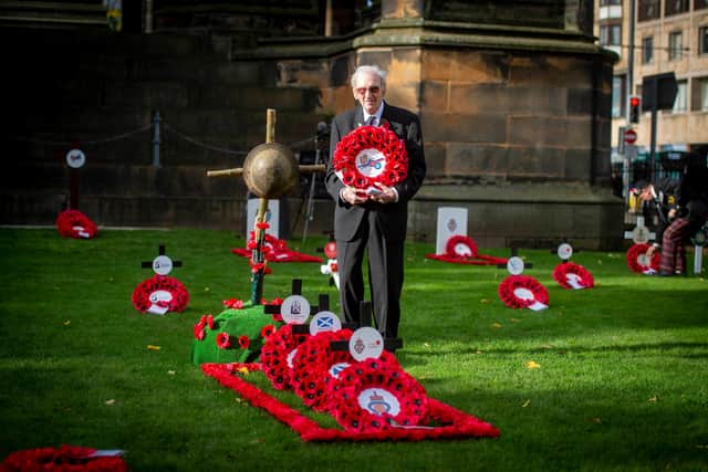 James White, 96, lays the Legion Scotland 100 Centenary wreath at the Garden of Remembrance today with son Jefferey  White, 67, providing a helping hand.