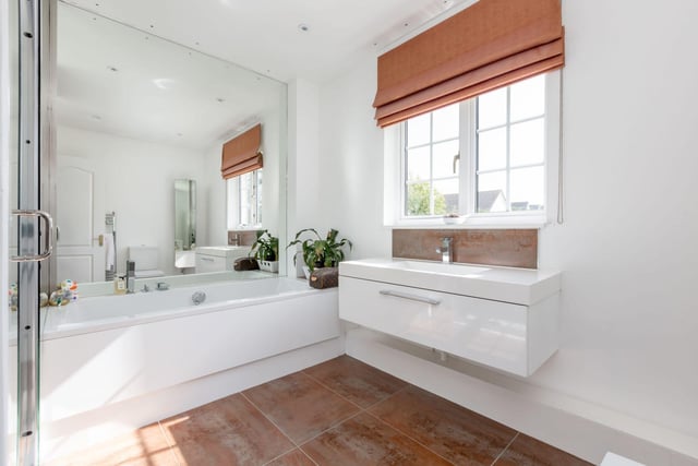 The stylish family bathroom on the upper level which boasts both a shower and bath.