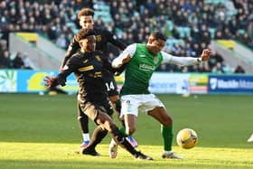 Demi Mitchell of Hibs and Livingston's Stephane Omeonga battle for the ball at Easter Road