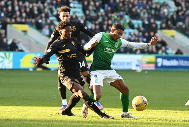 Demi Mitchell of Hibs and Livingston's Stephane Omeonga battle for the ball at Easter Road