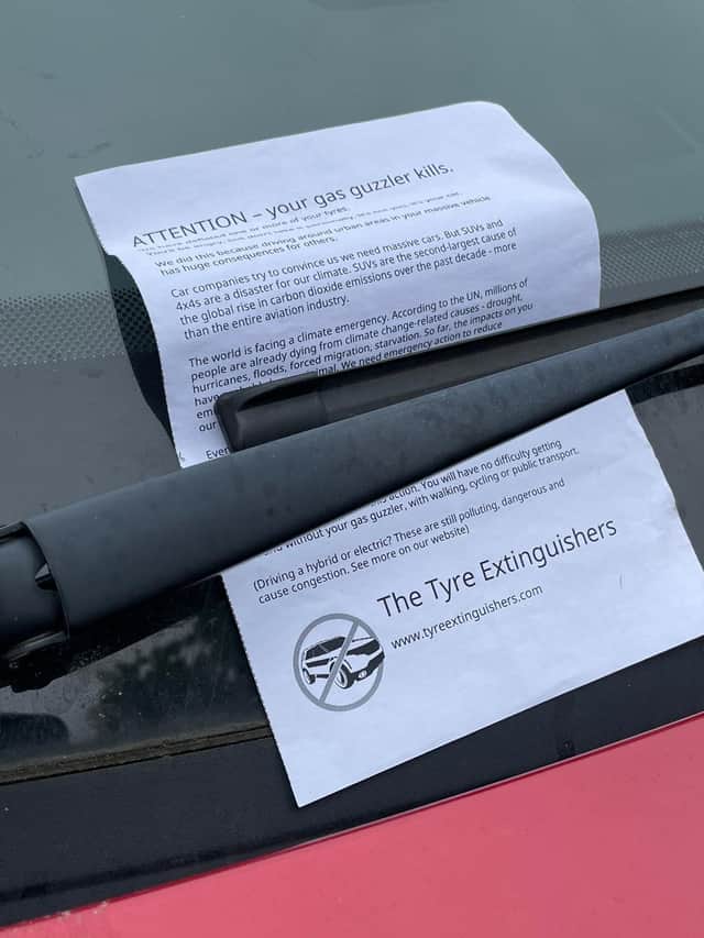 A note is left by the activists after they deflate tyres on vehicles