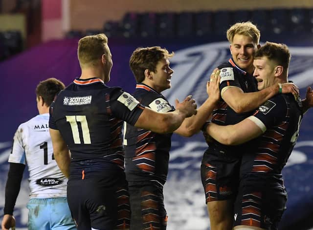 Edinburgh players celebrate the game's opening try by Magnus Bradbury, right. Picture: Ross Parker/SNS