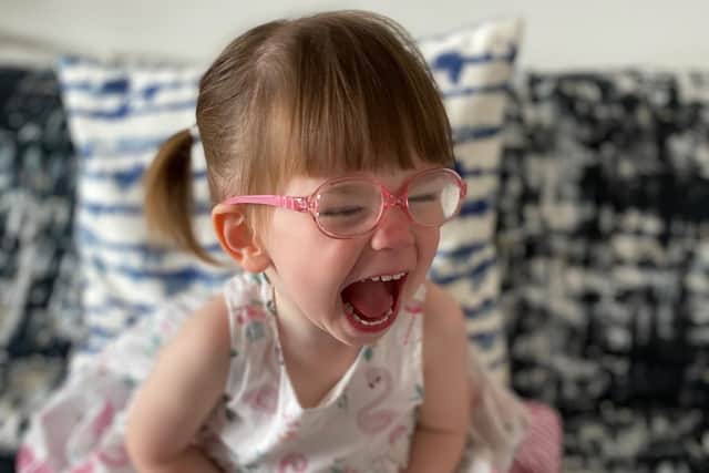 Harlow Kean, two, is delighted with her new pink specs