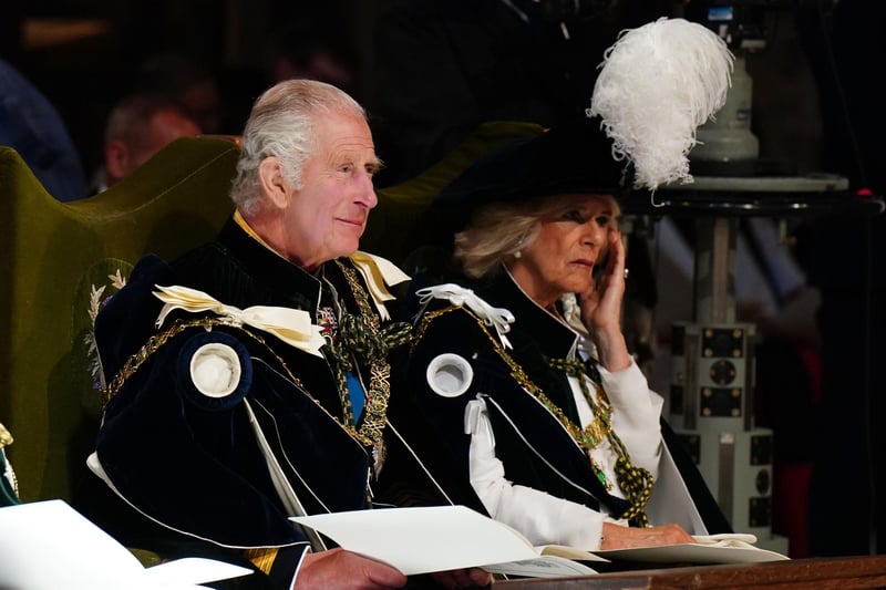 King Charles III and Queen Camilla listen intently at the service in St Giles.