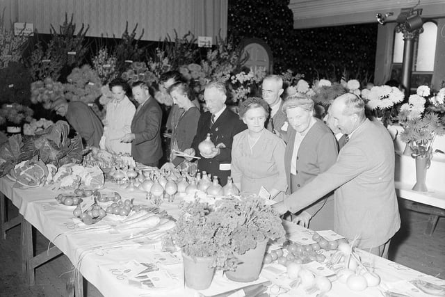 Visitors admire the vegetable exhibits at the Dalkeith and District Flower Show in the Buccleuch Halls in August 1961.