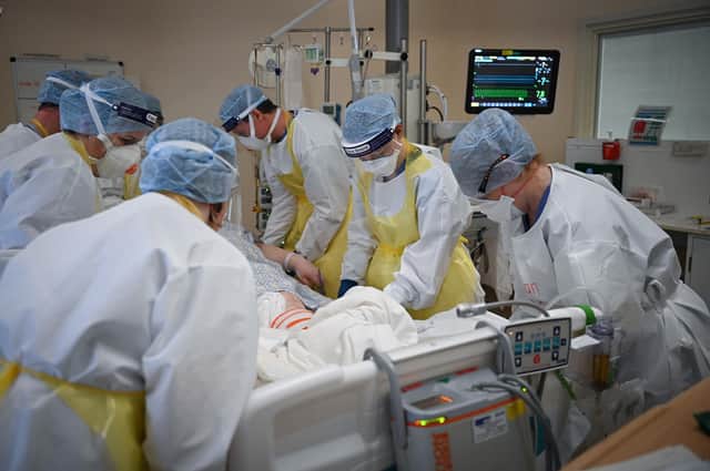 Staff at University Hospital Monklands attend to a Covid-positive patient on the ICU ward on February 5, 2021 in Airdrie, Scotland. Photo by Jeff J Mitchell/Getty Images