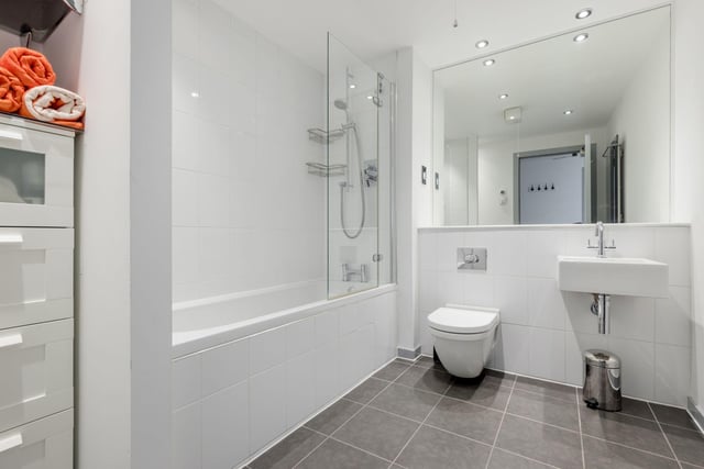 The property's stylish main bathroom with shower over bath.