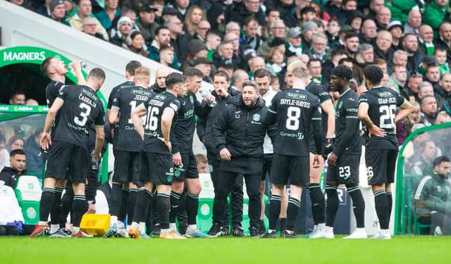 Lee Johnson speaks to his outfield players during a break in play in the 3-1 defeat by Celtic