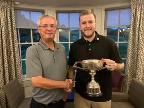 Bathgate's Scott McCandless, right, is presented with the Lothians Champion of Champions Trophy by LGA President Neil Anderson. Picture: LGA